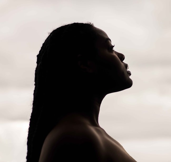 Black Women Side Profile With White Cloudy Background