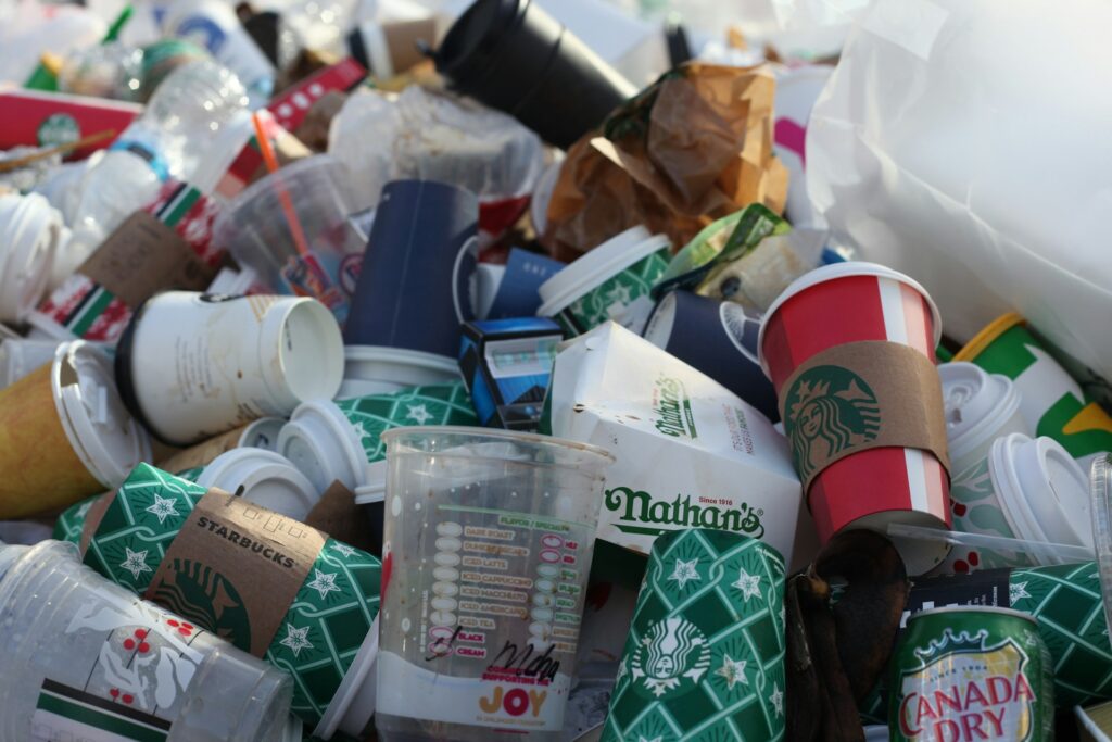 A pile of food wrappers and coffee cups displays the names of famous NYC restaurants